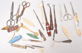 A collection of vintage and antique sewing related items to include ivory thread winders, decorative