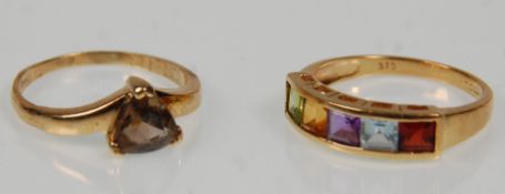 Two hallmarked 9ct yellow gold ladies rings. One set with five multi coloured stones to a pierced