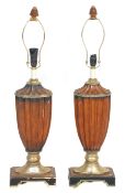 A pair of 20th Century antique style faux wooden table lamps having urn shaped reeded bodies