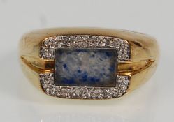 A thick 9ct yellow gold ring set with a blue stone panel and split diamond illusion surround.
