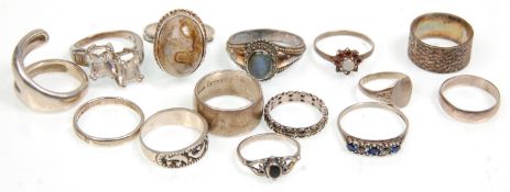 A group of fourteen silver ladies rings of varying sizes and designs to included three bands,