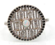 A stamped 925 silver ring having a large round head having pierced greek key decoration set with