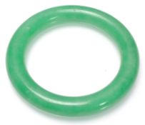A Chinese Jade slave bangle of typical round form.