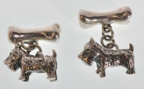 A pair of stamped 925 silver cufflinks in the form of Scottish terriers with bone toggles. Weight