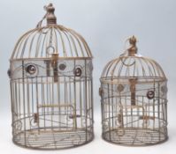 A pair of graduating 20th Century decorative bird cages having rope twist decoration and red stone