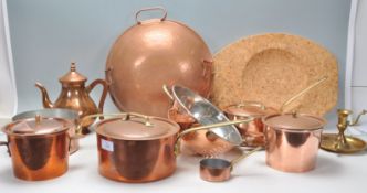 A collection of copper kitchen wares to include Jean Matillon copper saucepans, copper colander, ice