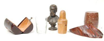 A collection of antique treen ware to include a turned olive wood dice shaker, a cast bronze bust of