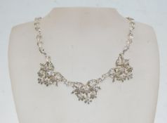 An Art Nouveau style silver and marcasite ladies necklace having a hook clasp. Stamped silver and