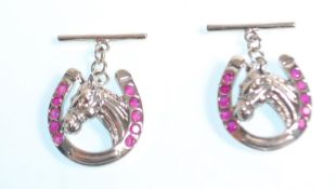 A pair of stamped 925 silver cufflinks in the form