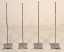 A matching set of four surround sound speaker stan