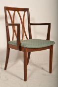 A 20th Century carver arm chair having a teak wood