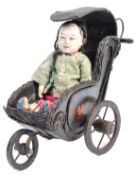 EARLY 20TH CENTURY COMPOSITE CHINESE DOLL AND PRAM