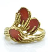A hallmarked 18ct gold and coral ' comet ' ring.