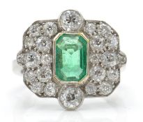 An 18ct white gold emerald and diamond ring.