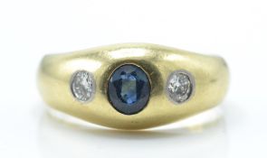 A 14ct / 585 gold sapphire and diamond dome ring. The ring set with a central oval mixed cut sapphir
