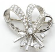 An 18ct gold, platinum and diamond Cartier brooch pin in the form of a ribbon spray