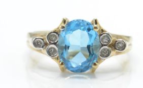 A hallmarked 9ct gold topaz and diamond ring.