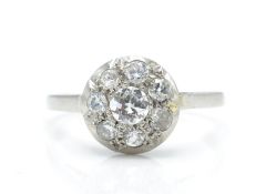 A platinum and diamond cluster ring. The ring having a central diamond of approx 0.25ct surrounded