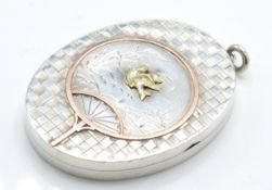 A Victorian 19th century silver and gold hair locket of oval form