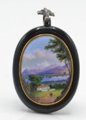 An antique Swiss pendant of oval form being set wi