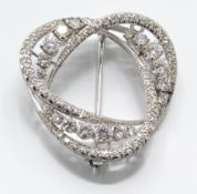 An 18ct white gold and diamond brooch pin. The brooch being set with elliptical arches