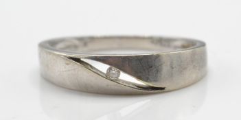 A 9ct white gold and diamond ring with a central round brilliant cut diamond