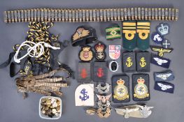 A collection of assorted military and Royal Navy uniform patches and accessories to include a