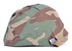 UNIFORMS AND FANCY DRESS - A BRITISH ARMY HELMET WITH CAMOUFLAGE COVER.