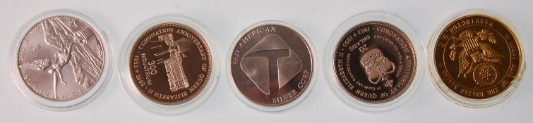 A group of four silver coins to include a Mexican