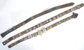 COLLECTION OF WWII SOUVENIR CAP BADGE ' HATE ' BELTS