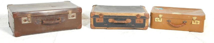 A group of three 20th Century vintage retro suitcases to include a black example with brown