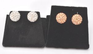 Two pairs of silver ball style earrings. The silver ball earrings terminate in a friction back.