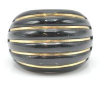 An Italian 14ct gold and onyx dome ring. The ring set with 14ct gold banding to a carved dome onyx