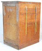 A 1940's Art Deco oak chest of drawers with two drawers above a cupboard below all having Deco