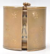 A vintage retro travel alarm clock by Europa with a brass and ebonised chapter ring featuring arabic
