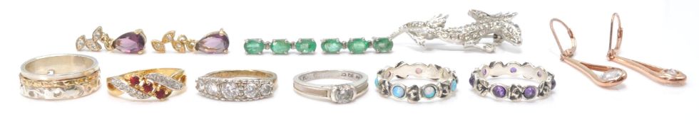 A selection of rings to include a stamped 925 silver eternity ring set with purple stone