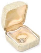 An 18ct gold and platinum diamond cluster ring. The ring having a central round brilliant cut