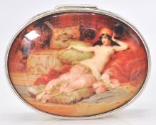 A large contemporary silver pill box with an enamel hinged lid depicting a a semi nude lady.