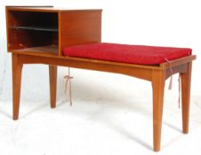 A retro mid century teak wood telephone table bench. Raised on tapering legs with a moquette
