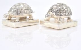 An unusual pair of silver plate salt and pepper shakers in the form of tortoises. Total weight 145.