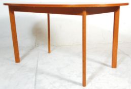 A retro mid 20th Century teak wood extending dining table of oval form raised on square tapering