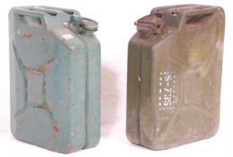 Two vintage 20th Century military jerry petrol cans, both retaining original green paintwork with