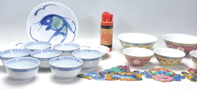 A collection of 20th Century Chinese / Japanese blue and white rice bowls with floral and plantain