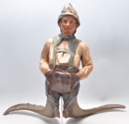 A large Carved German  - Bavarian wooden sculpture of a gentleman in lederhosens with horn legs -