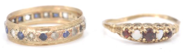 Two 9ct yellow gold ladies rings. One set with red stones and opal cabochons to a decorative