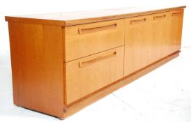 A vintage retro mid 20th Century Meredew teak wood sideboard having three cupboard doors beside a
