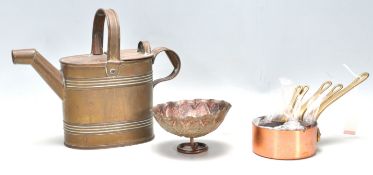 A small group of copper and brass wares dating from the 19th Century to include a copper and brass