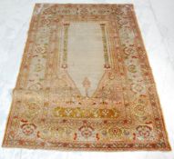 A 20th century Persian / Islamic floor rug. The rug with beige central panel flanked by geometric
