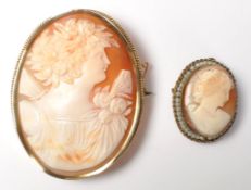 Two vintage 20th Century cameo brooches having carved conch shell panels,  both set in yellow