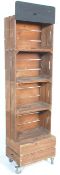 A group of five converted storage crate shelf display / bookshelf unit raised on castors.